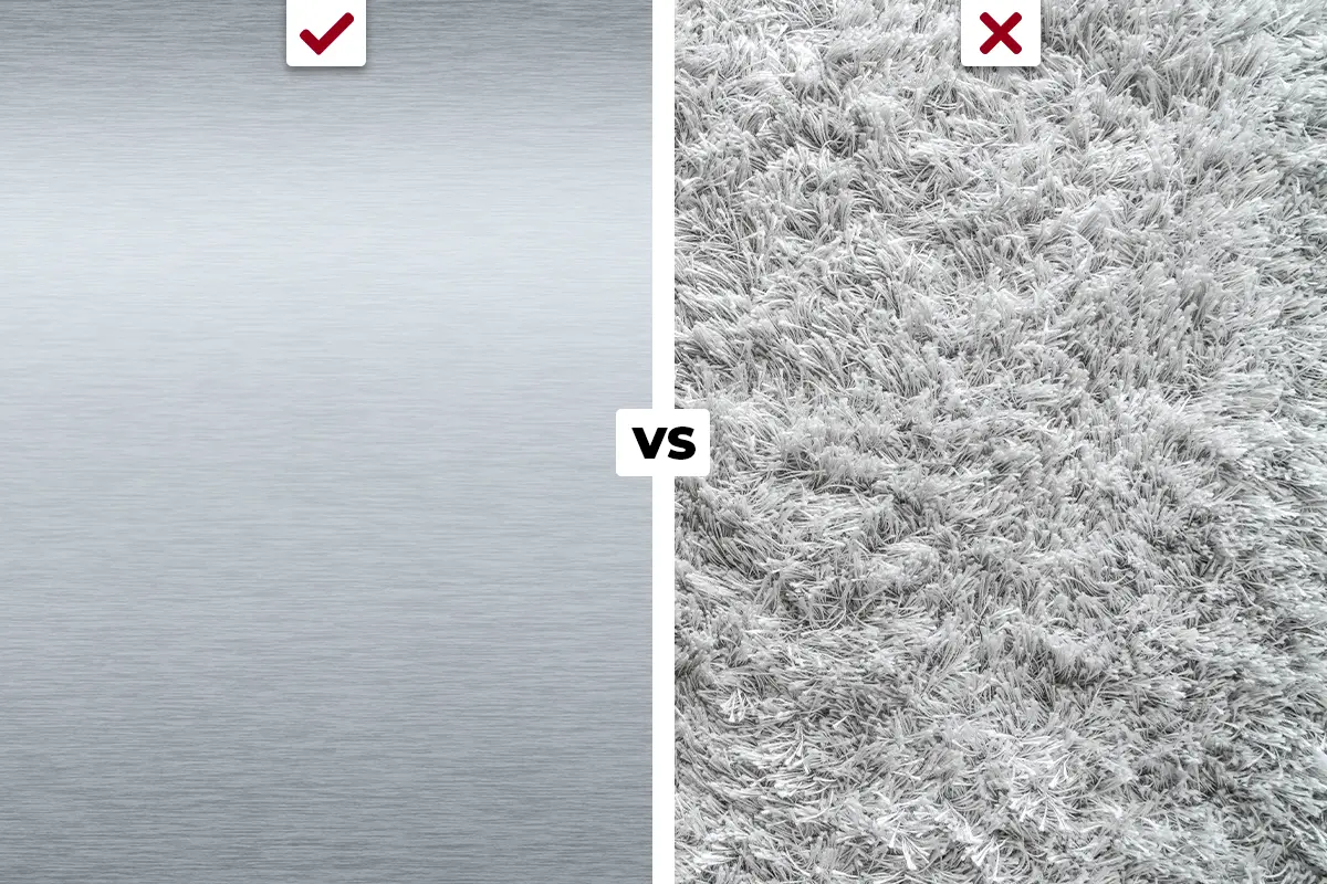 Comparison of cleanroom materials: stainless steel on the left with a green checkmark indicating it is suitable, and carpet on the right with a red X indicating it is not.